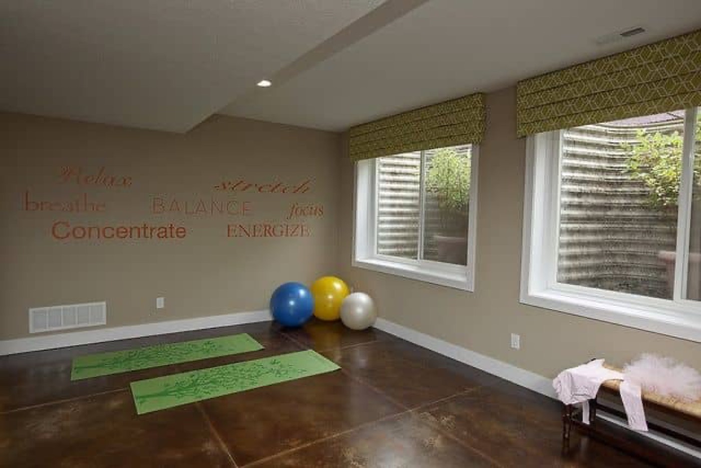 A basement play room lit by two windows set high in the wall
